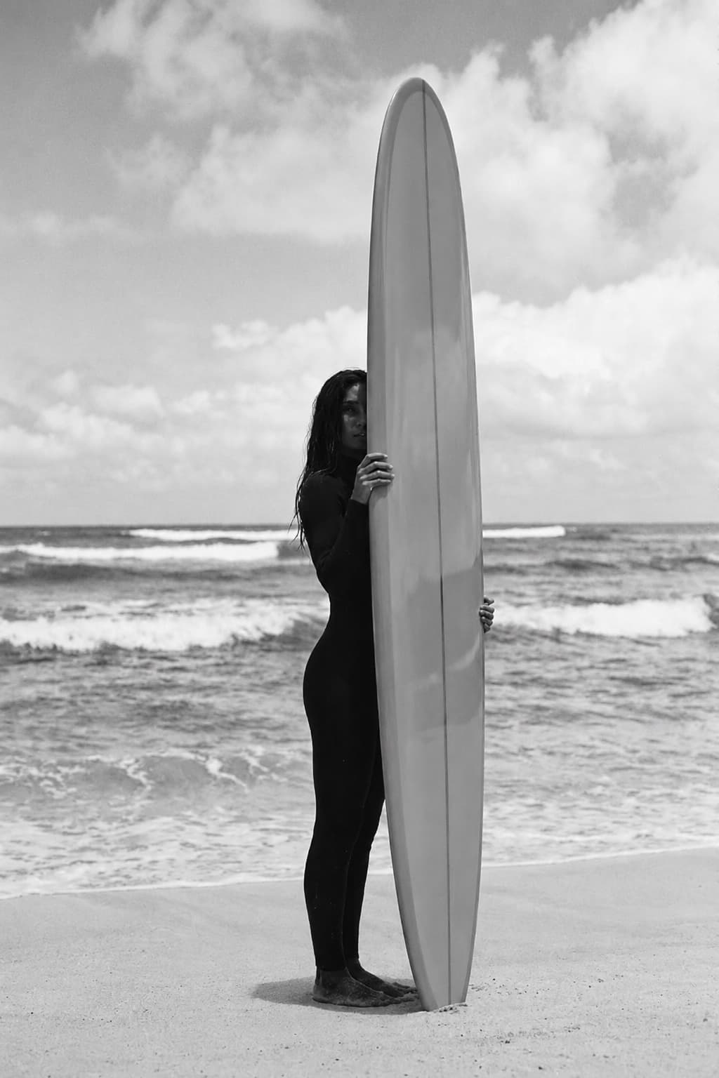 A yellow longboard in the sand