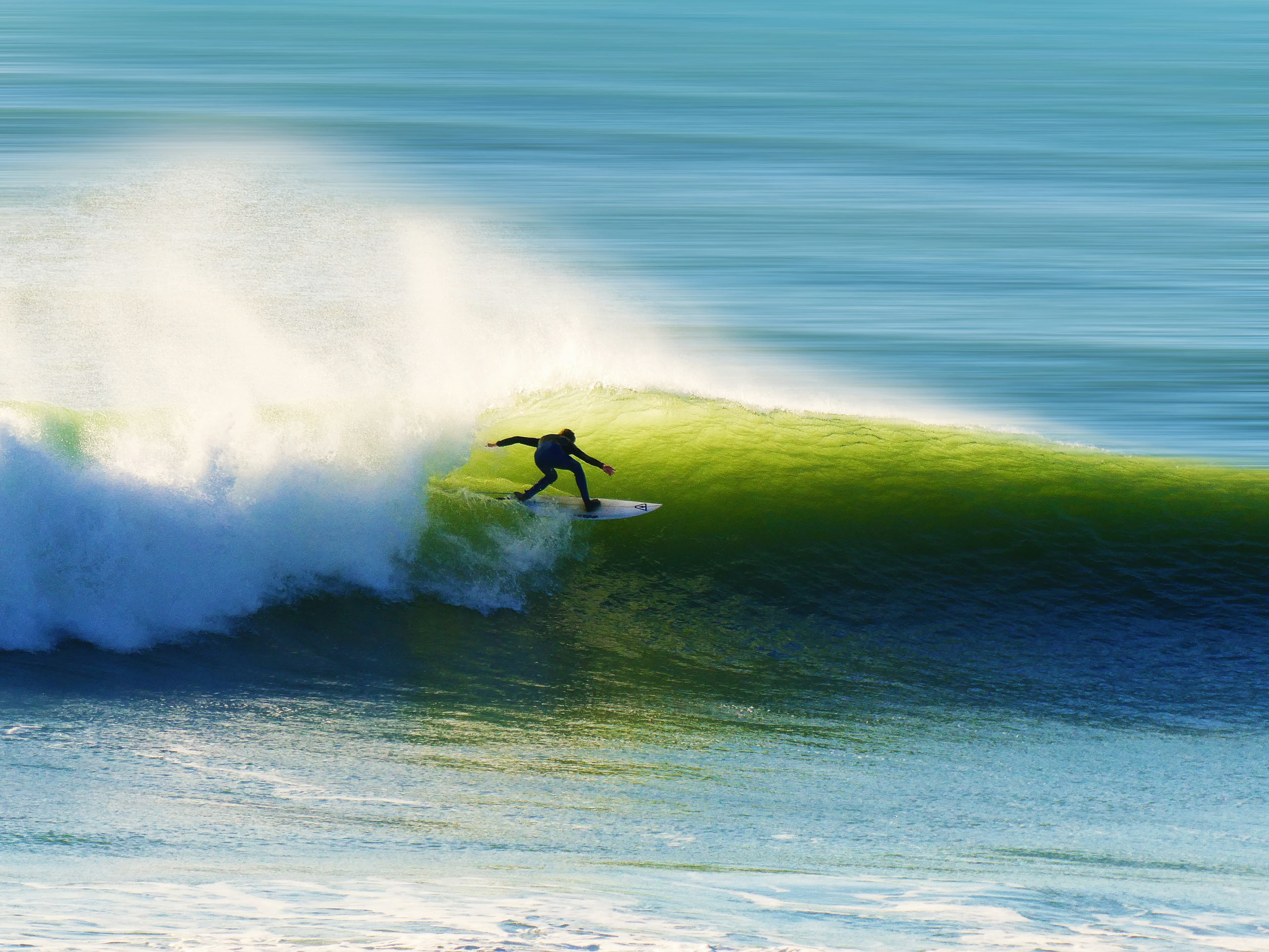 A surfer throwing bright spray